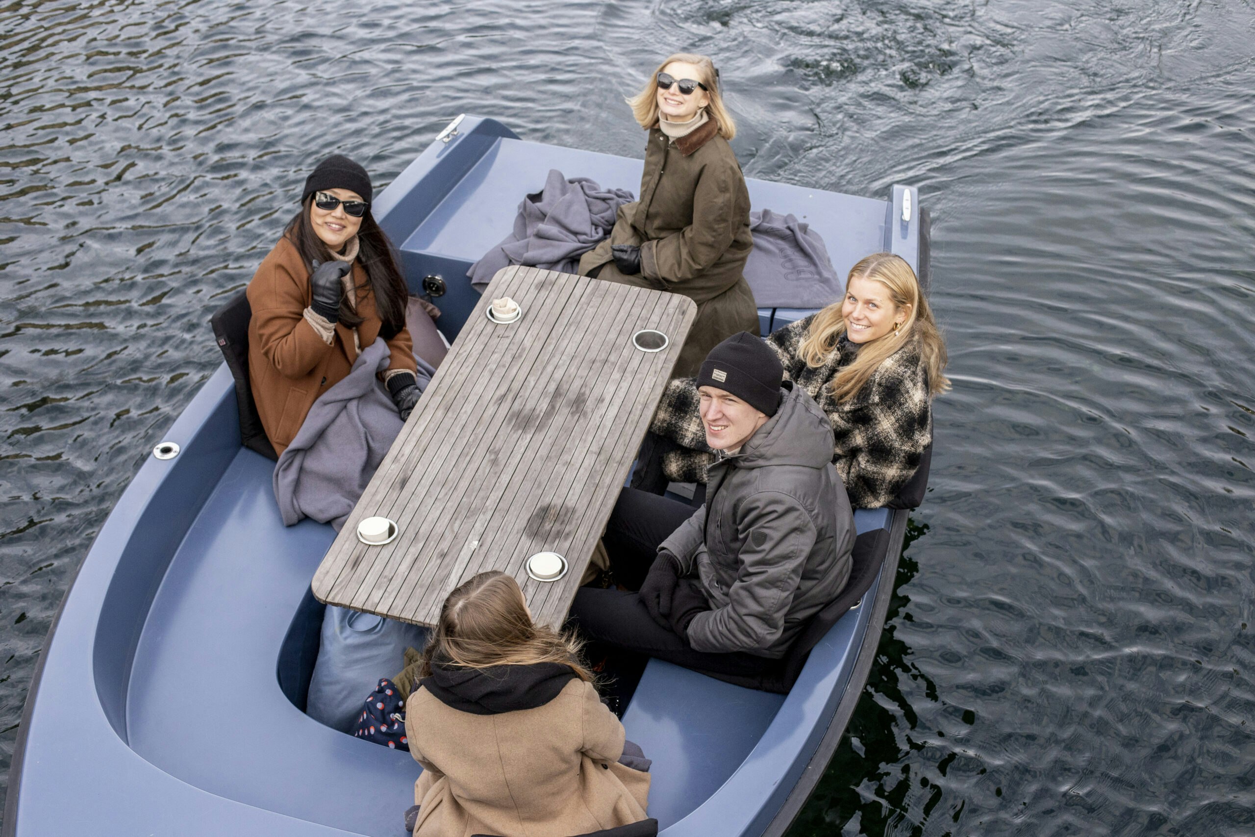 People sitting around picnic table in a GoBoat
