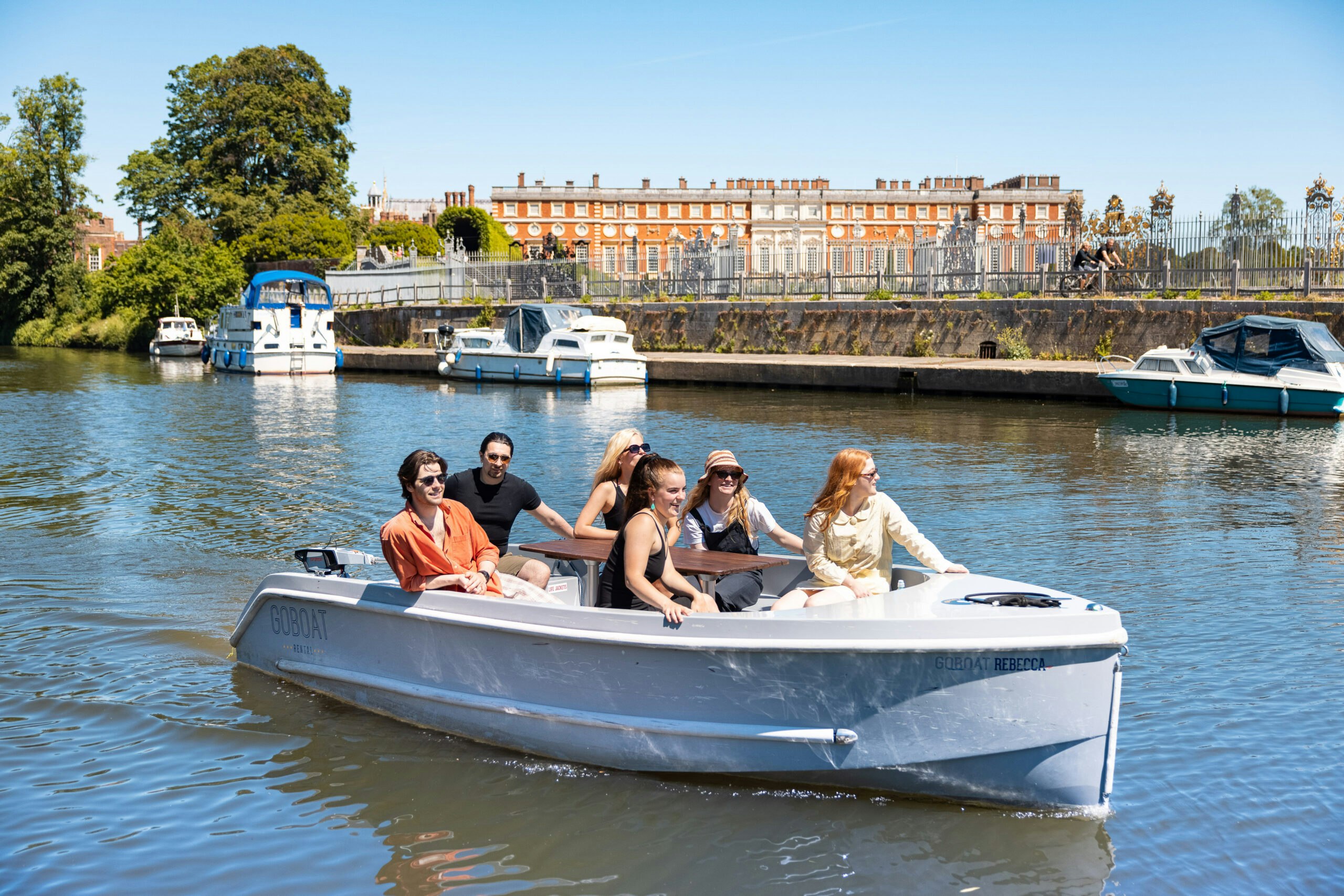 Friends on GoBoat passing Hampton Court Palace